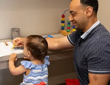 Father and daughter in play area